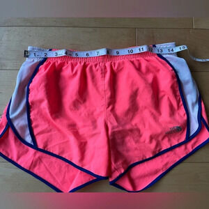 Neon pink North Face athletic running shorts with blue white trim, size small S